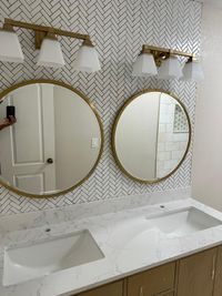 Compact Modern Bathroom with Wood and Marble Accents: A compact bathroom featuring a walk-in shower with wood-look tile and marble accents, complemented by a sleek vanity and modern lighting.