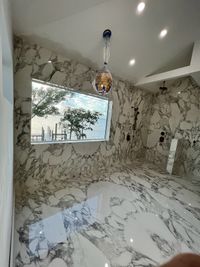 Luxury Shower with Black Hexagon Tile and Glass Enclosure: A modern luxury shower featuring black hexagon tiles, dual rain showerheads, and a sleek glass enclosure for a premium bathing experience.
